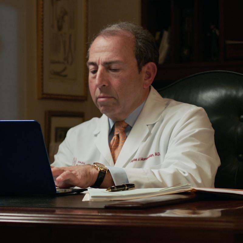 Douglas M. Monasebian, MD, FACS at his desk