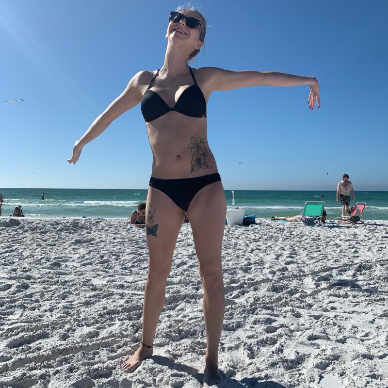 Angel at the beach spreading out her arms