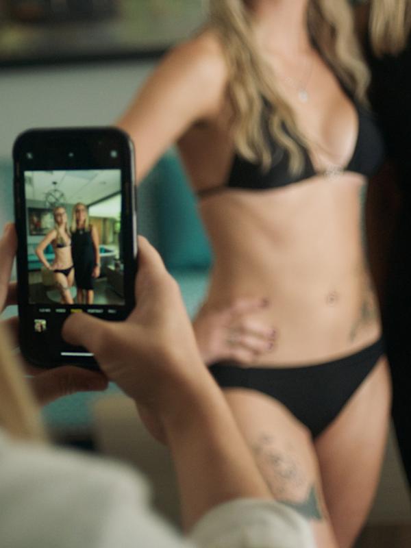 Angel getting her photo taken in a black bikini