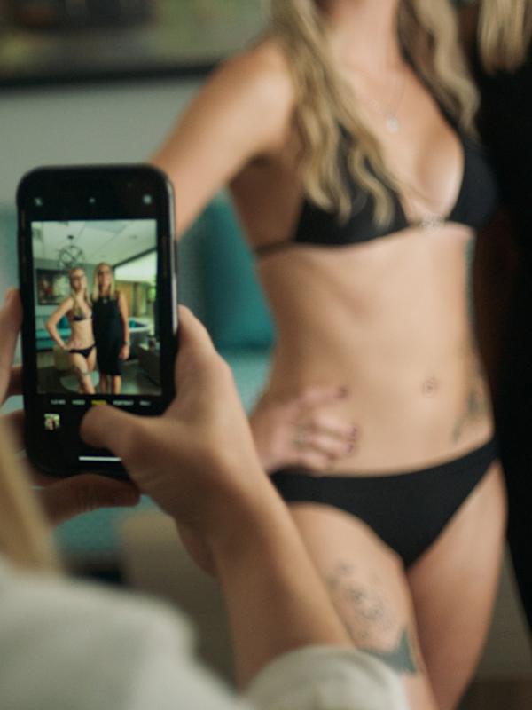 Angel getting her photo taken in a black bikini