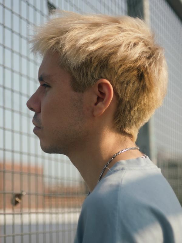 Jesse staring through a chain-link fence