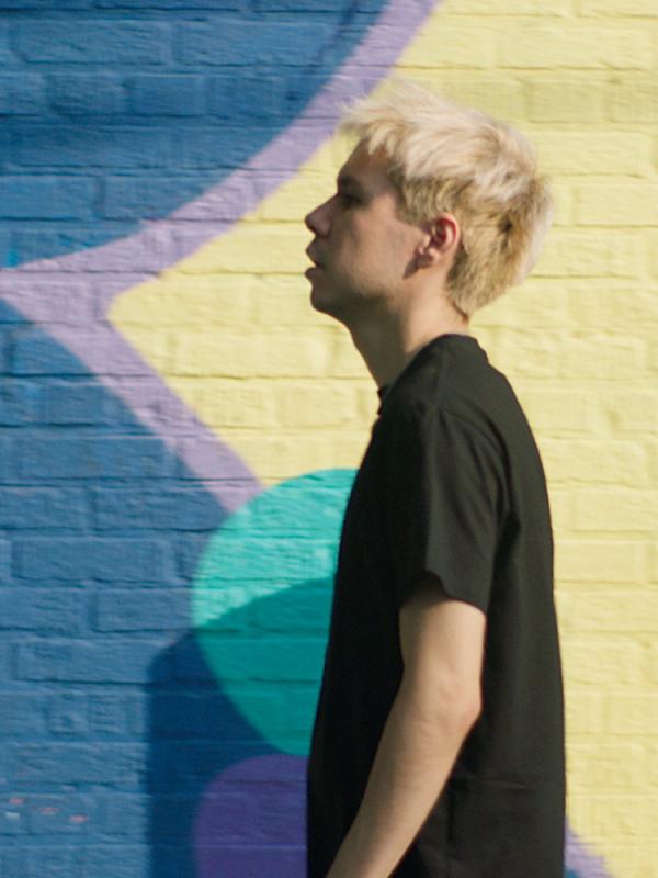 Jesse in front of a colorful wall