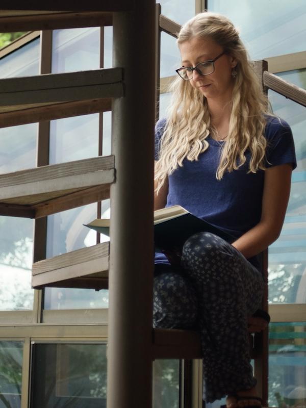 Angel reading on a spiral staircase