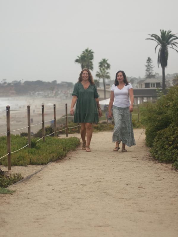 Joy and Erica walking beside the beach