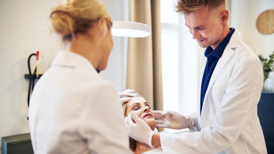 Plastic Surgeon examining a patient