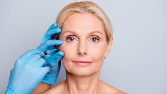 Woman getting fat transfer facial rejuvenation