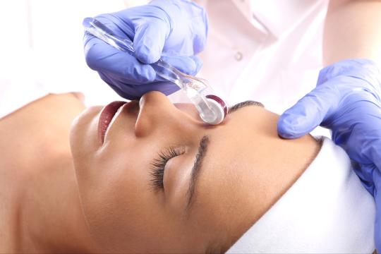 Woman undergoing Microneedling procedure