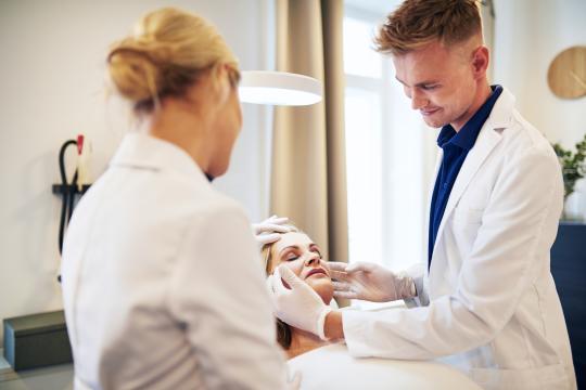 Plastic Surgeon examining a patient