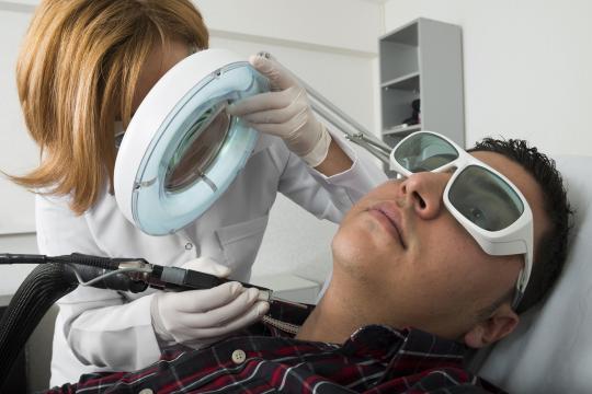Man getting nonsurgical cosmetic laser treatment