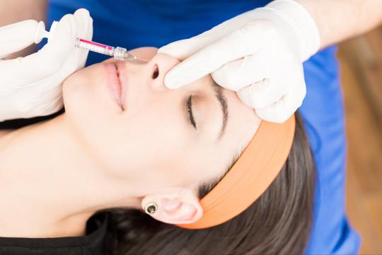 Women getting liquid rhinoplasty