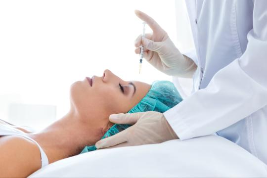 Woman getting injectable filler from a plastic surgeon