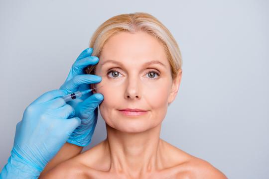 Woman getting fat transfer facial rejuvenation